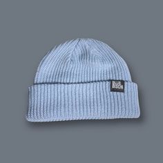 a light blue beanie hat on a grey background with the word bob's written in