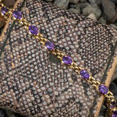 This wonderful bracelet features 13 oval cut amethysts and is crafted of 14k yellow gold. This bracelet measures 7 5/8 inches in length, fitting a 7.5 inch wrist. Golden Bracelet, Brand Presentation, Amethyst Bracelet, December Birthstone, High Quality Jewelry, Estate Jewelry, Oval Cut, Jewelry Bracelets, Amethyst