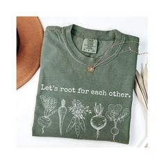 Comfort Colors® Let's Root For Each Other Shirt, Gardening Vegies Tshirt, Farmers Market Root Tee, Plant Lady Shirt, Homesteading Mom Tee ♥ Experience the ultimate comfort of Comfort Color garment-dyed shirts! These cotton-washed tees offer unrivaled comfort and a retro-vintage vibe. The colors are stunning and enduring, ensuring a timeless appeal that never disappoints. Plus, they stay pristine without piling, making them a true wardrobe staple. ♥ Our unisex sizing ensures a versatile fit that' Organic Crew Neck Tops For Spring, Organic Green Short Sleeve Top, Green Organic Relaxed Fit T-shirt, Cotton T-shirt With Letter Print For Gardening, Relaxed Fit Graphic Print Shirt For Gardening, Relaxed Fit Shirt With Graphic Print For Gardening, Green Plant Print Tops For Gardening, Green Tops With Plant Print For Gardening, Crew Neck Cotton Shirt For Gardening