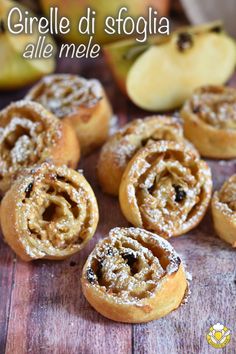 some apple pies sitting on top of a wooden table