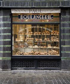 a store front with lots of baked goods in the window and sign above it that says paul boulangerie