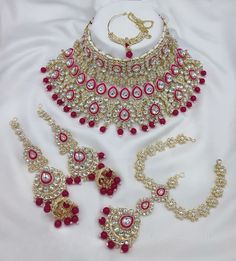 Description: Enhance your elegance with this stunning Traditional Indian Kundan Necklace Set featuring matching earrings, meticulously crafted to perfection. This exquisite jewelry set is the epitome of luxury, blending traditional design with contemporary flair, making it a must-have for every jewelry collection. Product Features: Material: High-quality Kundan stones, gold-plated alloy, and pearl detailing. Design: Intricately designed with a beautiful combination of beads that add a pop of color, perfect for any occasion. Earrings: Matching earrings with a comfortable fit, complementing the necklace perfectly. Necklace Length: Adjustable with a drawstring closure to suit your neckline and preference. Occasion: Ideal for weddings, bridal wear, engagements, festive occasions, and parties.