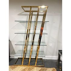 a display case with glass shelves in the middle and gold trimmings on each shelf