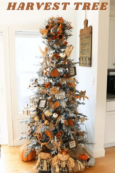 a decorated christmas tree in the corner of a room with an orange and white theme