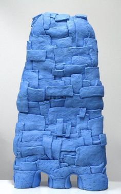 a blue sculpture made out of rocks on top of a table