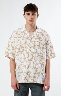 Bask in the tropical vibes with the Floral AOP Relaxed Camp Shirt from Tommy Jeans. With its collared neckline, short sleeves, and relaxed fit, it's perfect for laid-back days in the sun. Featuring a custom floral print throughout and a left chest pocket, this shirt draws inspiration from Hawaiian styles for a breezy, island-inspired look.


	Collared neckline
	Short sleeves
	Relaxed fit
	Button closures
	Lightweight
	Custom pattern
	Left chest pocket
	100% Cotton
	Machine washable
	Model is wearing size medium
	Model Measurements: 6'1” Height, 31” Waist, 33” Inseam Shirt Drawing, Fashion Landscape, Classic American Style, Back Day, American Denim, Camp Shirt, Hawaiian Style, Tropical Vibes, Camping Shirt