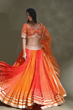 Dance the night away at weddings in this stunning orange and red lehenga with gota border and embroidered choli. It comes with a matching dupatta. Shop designer lehenga in USA from Pure Elegance. Orange Chanderi Lehenga With Resham Embroidery, Orange Anarkali Set For Reception And Festivals, Orange Chanderi Lehenga With Cutdana, Orange Chanderi Choli For Reception, Chanderi Choli In Orange For Receptions, Orange Dupatta For Reception And Festivals, Orange Dola Silk Choli With Dupatta, Orange Dola Silk Lehenga For Festivals, Orange Lehenga With Resham Embroidery For Diwali