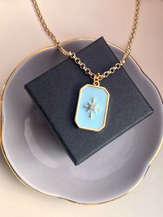 Beautiful, gold-plated necklace with a light blue pendant set with a clear crystal zircon stone. The chain is completely gold-plated with 24k gold, the total length of the necklace is 50 cm. The gold-plated link chain is 2 mm thick, the gold-plated carabiner is 9 mm long. The great, light blue star pendant is 25 mm long and 15 mm wide and has a thickness of 2 mm. The pendant has a gold border and is white and light blue on the inside. The pendant is decorated in the middle with a beautiful, gold Blue Pendant Necklace, Gold Border, Blue Pendant, Gift For Girlfriend, Crystal Stone, Gold Plated Necklace, Long Chain, Blue Star, Star Pendant