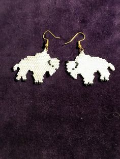 I have beaded these white Buffalo earrings with white delica glass beads. I have added matt black for the Buffalo features. I have crafted these earrings out of white beads but other colors could be used, personalize with the color you want.  I just custom crafted special  colors for my thunder bird pattern that went to Hawaii. White Drop Earrings With Black Beads, White Dangle Jewelry With Black Beads, Gift White Beaded Earrings With Black Beads, Nickel-free White Beaded Earrings, White Beaded Earrings With Round Tiny Beads, White Nickel-free Beaded Earrings, Nickel-free White Round Bead Earrings, White And Black Beaded Earrings, White Beaded Earrings As Gift