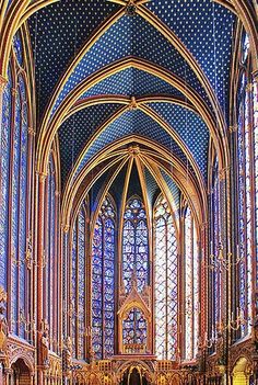 the inside of a large cathedral with stained glass windows