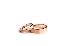 two wedding rings sitting on top of each other