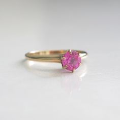 This lovely deep pink round brilliant cut sapphire is set in a warm rose gold six prong setting. This ring would make a beautiful alternative engagement ring. Metal: 14K Rose Gold Sapphire: 5.3 MM Size: 5.25 For a greater selection of jewelry please visit our website at www.BlackMarketLLC.com If you have any questions about this product or if we can help you with any of our other products please contact us through Etsy or our website at www.blackmarketllc.com. Each piece of our jewelry has been Classic Pink Ruby Ring With Center Stone, Pink Brilliant Cut Round Ruby Ring, Pink Brilliant Cut Ruby Ring, Classic Pink Birthstone Ring For Formal Occasions, Fine Jewelry Pink Round Cut Ruby Ring, Fine Jewelry Pink Ruby Ring With Round Cut, Pink Round Cut Ruby Ring, Classic Pink Ruby Ring For Anniversary, Classic Pink Ruby Ring With Brilliant Cut