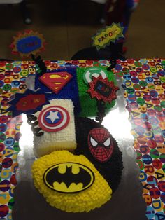 a birthday cake that has been decorated to look like batman and captain america on it