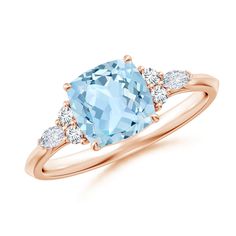 a ring with an aqua blue topazte and three white diamonds on the side