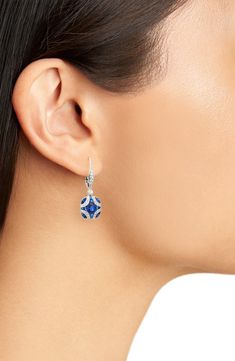 These 18-karat gold earrings deliver vintage-inspired style with an elegant argyle pattern in blue sapphires and fiery diamonds. 1" drop; 1/2" width Lever-back closure Total diamond weight: 0.35ct. Total sapphire weight: 0.38ct. Color: G-H Clarity: VS1-VS2 18k gold/sapphire/diamond Made in the USA >Diamond Guide Luxury Blue Diamond Earrings With Accents, Luxury Blue Diamond Drop Earrings, Elegant Blue Diamond Earrings With Pave Setting, Sapphire Diamond Accented Drop Earrings, Blue Diamond Cut Earrings Fine Jewelry, Blue Diamond Cut Earrings In Fine Jewelry Style, Blue Diamond Cut Diamond Earrings, Blue Diamond Earrings With Pave Setting, Evening Sapphire Earrings With Diamond Accents