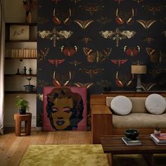 a living room filled with furniture and wallpaper covered in butterflies on the back wall