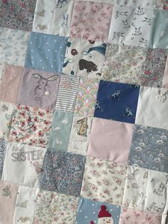 a patchwork quilt with various designs and animals on it's sides, including snowmen