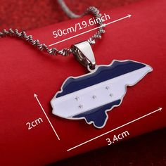 a blue and white state shaped pendant on a red background with measurements for the chain