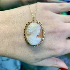 Metal: 14kt Yellow Gold Stone: Shell Shape: Oval Weight of entire piece with chain: 6.60 grams Length Of Cameo Including Bail: 33.00 mm Width Cameo : 23.00 mm Closer Type: Pin Stem With Side Catch Closer Age: Vintages, approximately from the 1960's. Type Of Chain: Rolo Chain Width Of Chain: 1.00mm Type Of Lock: Lobster Lock Length Of Chain: 18inches Jewelry Type: The back on this cameo has a pin to wear it as a brooch, as well as a loop that folds back and forth wear it as a pendant, on a chain. Luxury Gold Cameo Jewelry, Fine Jewelry Necklaces With Brooch For Anniversary, Antique Yellow Gold Necklace With Cabochon, Luxury Gold Cameo Necklace, Luxury Cameo Pendant Jewelry, Yellow Gold Medallion Necklace With Cabochon, Elegant Oval Cabochon Brooch Jewelry, Oval Brooch Necklaces For Wedding, Oval Brooch Necklace For Wedding