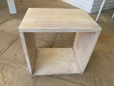 a wooden table sitting on top of a tiled floor