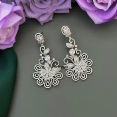 Silver cubic zirconium chandbali earrign with floral design. Inspire your style with this premium quality elegant diamond earring for reception, wedding, cocktail or any other ocassions.  Made with premium quality cubic zirconium diamond in  silver rohodium finish.   All orders Ship same day if placed before 4:00 PM EST  Create beautiful memory for any occasion with elegant jewelry for your loved ones You will receive carefully packaged items in jewelry box, ready to give memorable gift to your Silver Drop Earrings With Intricate Design, Silver Chandelier Earrings With Intricate Design For Reception, Elegant Dangle Chandelier Earrings For Reception, Sparkling Stones Drop Earrings For Wedding, Elegant Diamond Chandelier Earrings For Reception, Cubic Zirconia Flower Earrings For Wedding, Formal Dangle Flower Earrings With Cubic Zirconia, Intricate Cubic Zirconia Dangle Bridal Earrings, Intricate Dangle Bridal Earrings With Cubic Zirconia