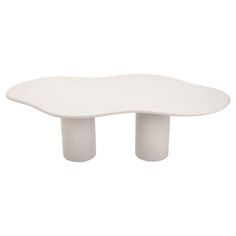 a white table with two legs and a large oval shaped object in the middle of it