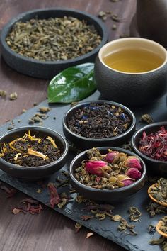 several bowls filled with different types of tea