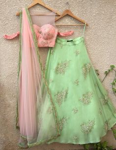 This set features peach blouse with gota work and pleat cold-shoulder detail; teamed with pista green pearl buti lehenga on net with raw silk Pista Green Lehenga, Lehenga Design, Simple Lehenga, Pista Green, Indian Outfits Lehenga, Lehnga Dress, Peach Blouse, Gota Work, Green Lehenga