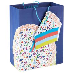 a blue gift bag with colorful paper decorations on it