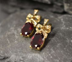 Gold Ruby Earrings set with a Created large Red Ruby in a perfect diamond cut & flawless clarity - large size stone (14x10 millimetres) at 16 Carats a pair! Gold Ribbon Earrings made of Solid 925 Sterling Silver ☞ made to last. **The earrings are plated with 18k Gold (the thickest plating - 3 Micron) over Solid 925 Sterling Silver. Matching Ring: www.etsy.com/listing/761090812 Matching Pendant - please ask me ⌛ Last pair of earrings left ⌛  For Pierced Ears - has a pin that goes into the ear and Red Diamond Earrings, Ruby Earrings Gold, Gold Ruby Earrings, Diamond Earrings Gold, Ribbon Earrings, Morganite Pendant, Matching Ring, Real Jewelry, Red Diamond