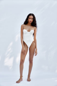 One piece featuring a cut-out inspired by the rhythmic movements of the ocean.
Your ally on any getaway, this versatile piece can be used as a swimsuit with sandals and your favorite sunglasses, or take it out in the town by adding high-waisted bottoms, dainty jewelry, and strappy heels. In The Town, One Piece Swim, Dainty Jewelry, Strappy Heels, Resort Wear, The Ocean, Luxury Design, Cut Out, High Waisted