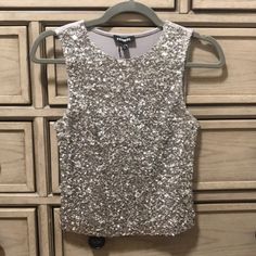 Brand New With Tags Express Metallic Sequin Embellished Tank Size Xs Crew Neck Sleeveless; Lined Straight Hem; Hits At Waistband Silver Sequin, Pearl And Crystal Accents; Soft Gray Back Fabric Nylon/Viscose Hand Wash Imported Glamorous Silver Tank Top For Party, Silver Embellished Party Top, Glamorous Silver Party Tank Top, Silver Sleeveless Tank Top For Night Out, Silver Fitted Tank Top For Party Season, Silver Fitted Tank Top For Party, Silver Tank Top For Spring Party, Silver Tank Top For Spring Night Out, Sparkling Sleeveless Tops For Party Season