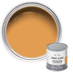 an orange paint can with the lid open and next to it is a white background