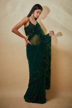 Green saree with sequins hand embroidered borders. Comes with a blouse and an underskirt.
Components: 3
Pattern: Hand embroidered
Type Of Work: Sequins
Neckline: Leaf Neck
Sleeve Type: Sleeveless
Fabric: Tulle , Buttercrepe
Color: Green
Other Details: 
Heavily embroidered blouse
Occasion: Wedding - Aza Fashions Traditional Organza Pre-draped Saree With Sequins, Anarkali Pre-draped Saree With Sequins For Diwali, Semi-stitched Sequined Pre-draped Saree For Reception, Sequined Anarkali Pre-draped Saree For Diwali, Anarkali Sequined Pre-draped Saree For Diwali, Traditional Organza Saree With Sequins, Embellished Tissue Silk Saree, Traditional Organza Pre-draped Sequined Saree, Traditional Sequined Pre-draped Organza Saree