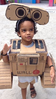 a young boy wearing a cardboard box costume