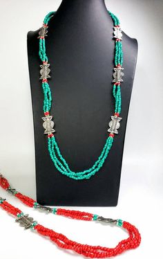 Add color and pizzazz to any outfit with this beautiful hand crafted Tibetan coral color multi strand bead necklace with silver tone amulets. The faux turquoise accents makes the amulets pop! A simple but very striking necklace! Perfect for a beach vacation with a carefree white dress or in the city to dress up jeans. Makes a beautiful gift! Twist the necklace for a totally different look! Excellent quality and craftsmanship. - 3 strands of irregular beads - bright red/orange color - silvertone Bohemian Multi-strand Silver Beads Jewelry, Bohemian Multi-strand Jewelry For Festivals, Bohemian Double Strand Necklace With Silver Beads, Bohemian Long Silver Beads Necklace, Bohemian Multi-strand Silver Beaded Necklaces, Bohemian Multi-strand Silver Beaded Necklace, Bohemian Long Necklace Beads In Silver, Traditional Double Strand Beaded Necklaces For Gifts, Red Bohemian Necklace With Silver Beads