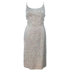 This cocktail dress is composed of an off white silk and is embellished with iridescent sequins. The spaghetti strap design features a center back zipper closure. In excellent vintage condition with original tags. **Please cross-reference measurements for personal accuracy. Size in description box is an estimation. Measures (Approximately) Length: 36.75" Bust: 35.5" Waist: 27.75" Hip: 40" 1940s Outfits, Long Cocktail Dress, Cocktail Outfit, White Cocktail Dress, Couture Vintage, Evening Wedding, Reception Dress, Red Carpet Dresses, White Silk