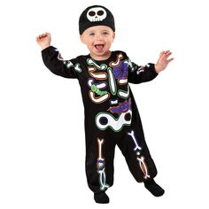 a young child wearing a black costume with skulls and bones on it's chest