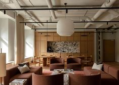 a living room filled with lots of furniture next to a dining room table and chairs