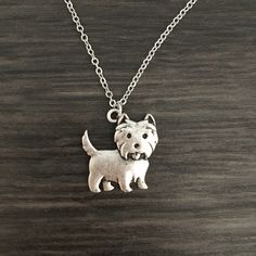 Accent your everyday outfits with this playful Westie necklace and display your favorite pooch! Hanging from a silver tone chain, this Westie pendant works well with an array of necklines for true versatility in your jewelry wardrobe. Paw-some for everyday wear, it consolidates your image as a dog person by adding a fun dog inspired finishing touch to casual and formal ensembles alike. Pick it for yourself or as a thoughtful gift for a dog lover - its subtle style and playful design bring a love Cute Hypoallergenic Silver Charm Necklaces, Sterling Silver Dog Tag Necklace With Charms, Cute Hypoallergenic Sterling Silver Necklaces, Cute Hypoallergenic Sterling Silver Necklace, Cute Silver Hypoallergenic Necklace, Sterling Silver Dog Tag Necklace With Adjustable Chain, Nickel Free Silver Dog Tag Necklace, Nickel-free Silver Dog Tag Necklace, Silver Nickel-free Dog Tag Necklace