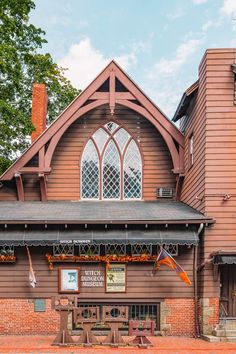 an old wooden building with a clock tower on the front and side of it's roof