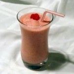 a smoothie is in a glass with a straw and a cherry on the top