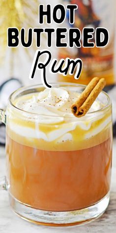 hot buttered rum in a glass mug with cinnamon sticks