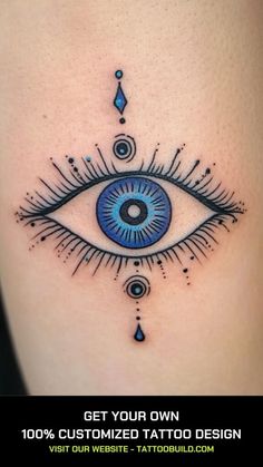 an eye tattoo on the side of a woman's thigh