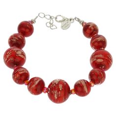 This gorgeous Venetian bracelet in rich fire red color is handcrafted on Murano Island in the glassworks of famous Murano glass masters whose craftsman lineage goes back centuries. It is is 100% hand-crafted using ancient Murano glass techniques. The bracelet features round beads of varying sizes generously infused with Avventurina sparkles for a unique shimmering look. Its festive style is sure to bring a touch of Venetian sun and opulence into your life. This Murano bracelet is a must-have for Elegant Red Round Bead Bracelets, Festive Red Artisan Jewelry, Festive Artisan Red Jewelry, Elegant Red Round Beaded Bracelets, Red Adjustable Beaded Bracelets For Formal Occasion, Red Adjustable Beaded Bracelets For Formal Wear, Adjustable Red Czech Glass Bracelet, Adjustable Red Czech Glass Bracelets, Elegant Glass Bracelets For Gifts