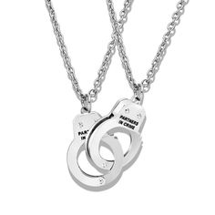 Celebrate unbreakable bonds with the Partners in Crime Handcuff Best Friends Forever Matching Necklace Set. This unique and stylish set features intricately crafted handcuff pendants, symbolizing a connection that lasts a lifetime. Perfect for best friends, this necklace set serves as a reminder of shared adventures, trust, and everlasting friendship. Each pendant is a testament to the special connection between two individuals, creating a meaningful and fashionable statement. Wear this set proudly and showcase the unbreakable bond that defines your friendship.   Crafted from durable stainless steel for lasting quality  Each necklace weighs 17g, providing a comfortable and substantial feel  Includes 2 matching necklaces, symbolizing a shared connection  Features intricately crafted handcuf Best Friend Necklaces For 2 Unique, Wood Inlay Rings, Punk Accessories, Bff Necklaces, Masonic Ring, Best Friend Necklaces, Stacked Necklaces, Fashion Pendant, Friend Necklaces