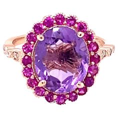 3.79 Carat Natural Amethyst Pink Sapphire Diamond Rose Gold Engagement Ring Playful yet Powerful! Its like having a piece of glittery candy on your finger! This ring has a bright Oval Cut Amethyst that weighs 3.10 Carats and is embellished with a halo of 20 Pink Sapphires that weigh 0.57 Carats as well as 12 Round Cut Diamonds along the shank that weigh 0.12 Carats. The total carat weight of the ring is 3.79 Carats. The ring is crafted in 14 Karat Rose Gold and weighs approximately 3.9 grams. The ring is a size 7 and can be re-sized at no additional charge. Rose Gold Diamond Ring Engagement, Pink Sapphire Ring, Purple Jewelry, Gold Cocktail Ring, Gold Cocktail, All Things Purple, Rose Gold Engagement, Gold Engagement Ring, Rose Gold Engagement Ring