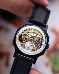 The exclusive Pobeda Sputnik Skeleton watch showcases exceptional craftsmanship with its open skeleton design, revealing golden gears and components set against a black case. The "Победа" brand name graces the center of the dial, surrounded by a white chapter ring with black minute markers for clear timekeeping. A unique rotating satellite disk at 6 o'clock serves as the second hand, adding a dynamic touch. The black stainless steel case, rare for Pobeda watches, adds to its allure. This 1960s mechanical timepiece, with a 35mm case and black mesh strap, is a true collector's item. Year: 1960's Case size: 35 mm  Case material: Stainless Steel Strap steel: Stainless Steel black mesh strap Movement: Mechanical Watch Gift For Him, Skeleton Design, Retro Watches, Watch Gift, Authentic Watches, Black Case, Skeleton Watch, Black Stainless Steel, Wristwatch Men