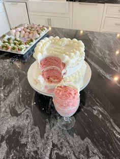 a cake sitting on top of a table next to two plates filled with desserts