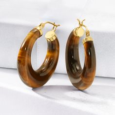 Ross-Simons - Tiger Eye Hoop Earrings in 14kt Yellow Gold. 1 1/8". Smooth and earthy, these hoop earrings feature tapered C-shaped tiger eye with polished 14kt yellow gold. Perfect to complement all of your neutral-hued outfits! Hanging length is 1 1/8". Snap-bar, tiger eye hoop earrings. Formal Tarnish Resistant Hoop Jewelry, Formal Polished Hoop Earrings, Formal Gold Plated Hoop Jewelry, Formal Hoop Earrings With Polished Finish, Gold Plated Hoop Jewelry For Formal Occasions, Gold Plated Hoop Jewelry With Polished Finish, Elegant Small Brown Hoop Earrings, Elegant Small Hoop Brown Earrings, Elegant Hinged Huggie Earrings